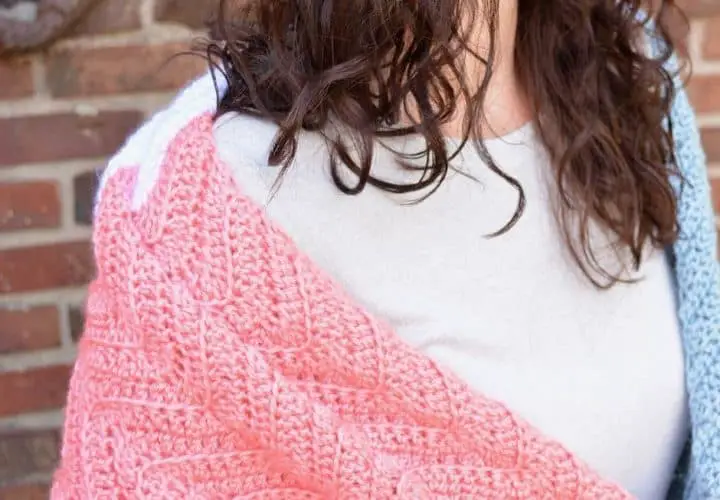 Close-up of a woman wrapped in a textured prayer shawl.