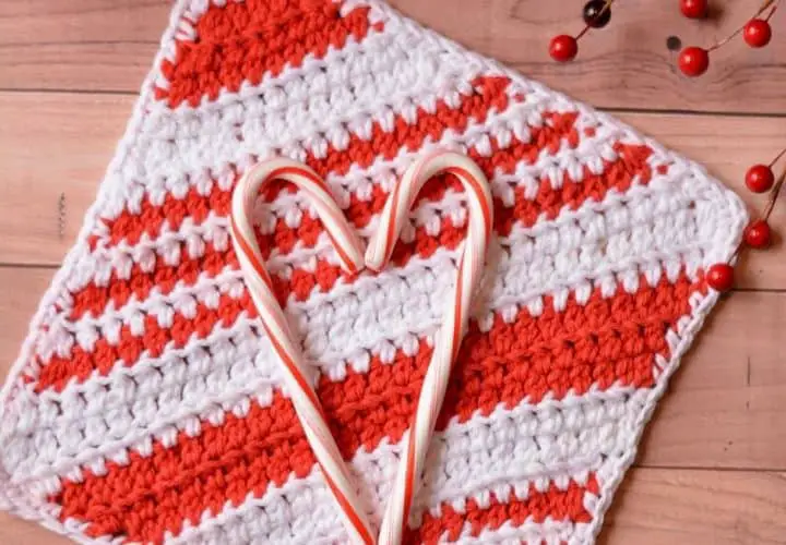 Candy cane hearts on top of a candy cane striped crochet washcloth