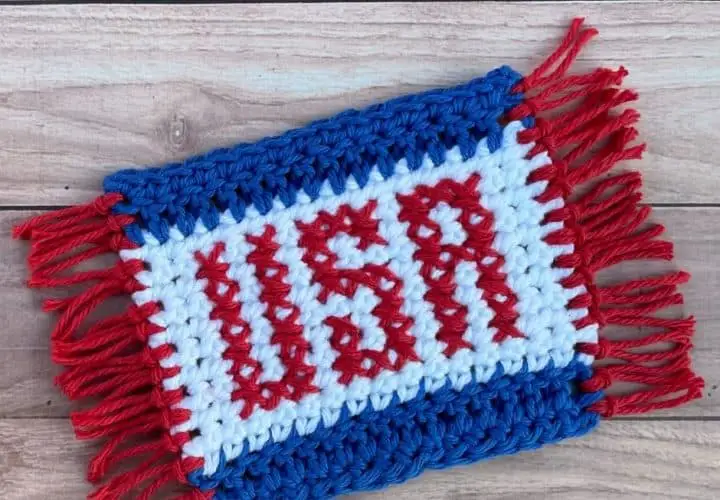A red, white and blue crochet coaster