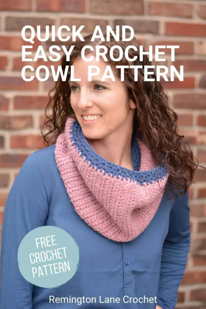 A smiling woman in a blue shirt wearing a dusty rose crochet cowl with denim blue trim
