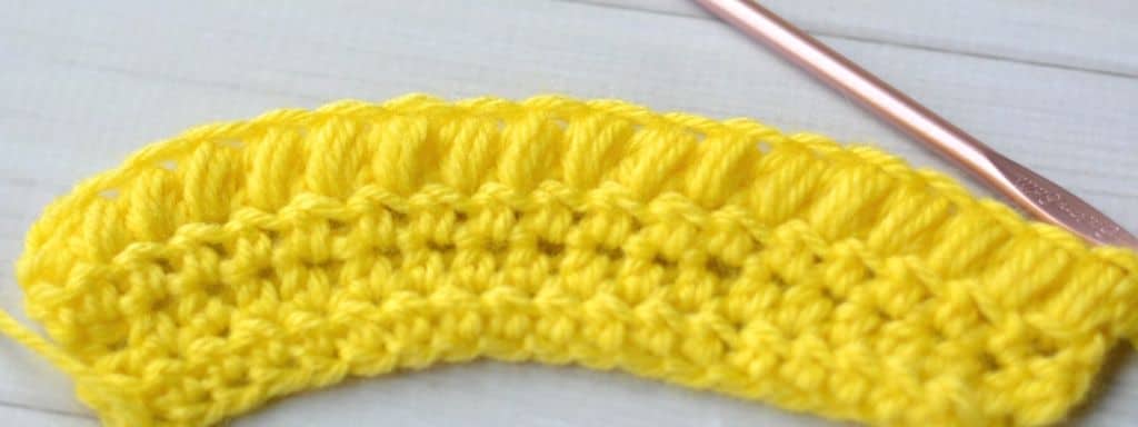 One row of puff stitches made with yellow yarn