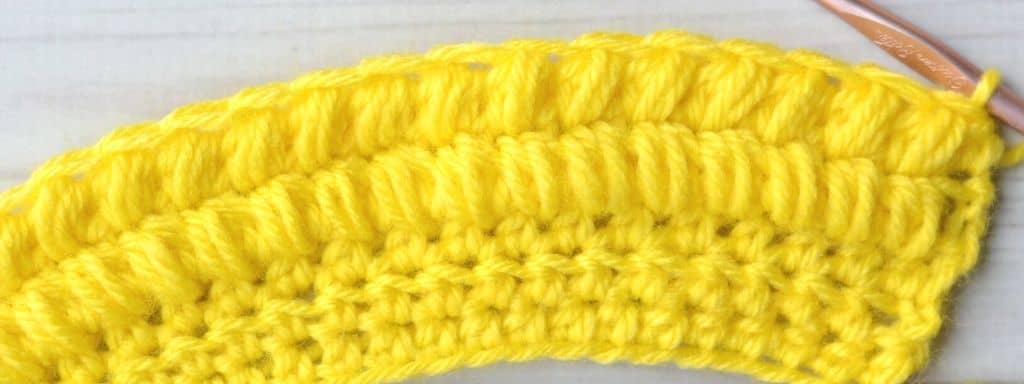 Two rows of puff stitches made with yellow yarn