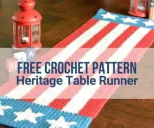 A wooden dining table with an American flag-themed table runner made out of yarn