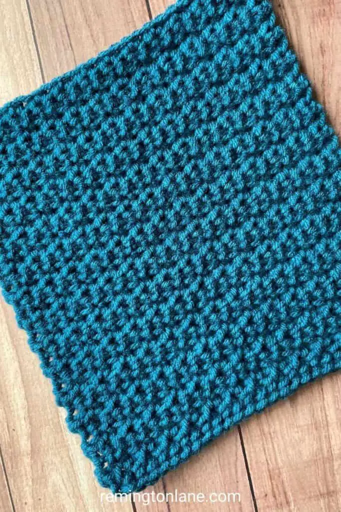Close up of a crocheted square made with ocean blue yarn