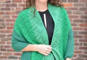 Woman modeling a crochet shawl for cool weather