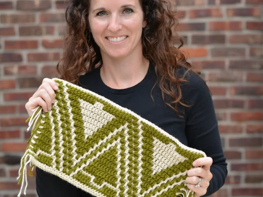 Woman holding an sample of this crochet pattern