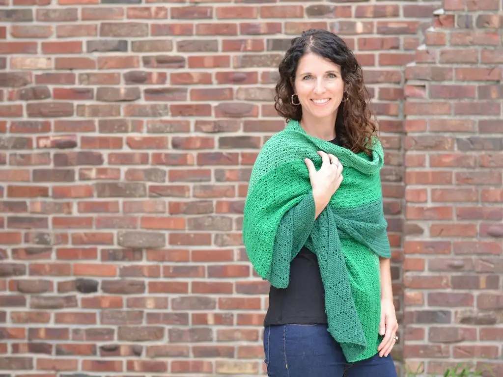 Smiling woman models a green shawl