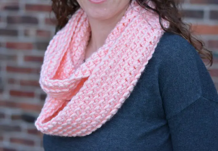 light pink double wrapped infinity scarf on a woman