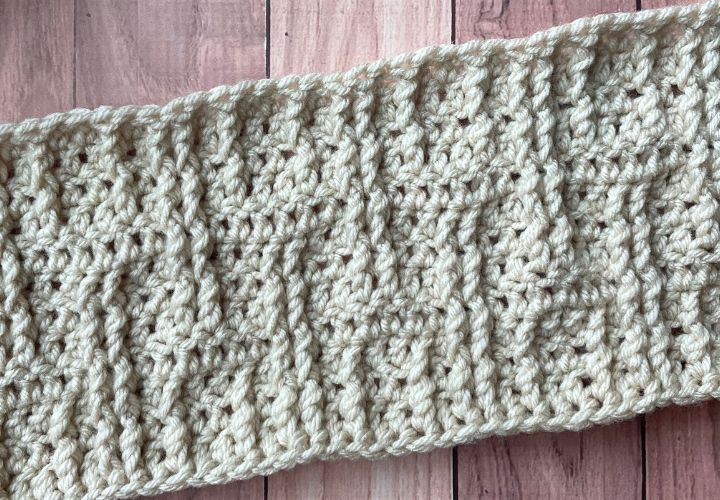 Cream crocheted blanket section on a table