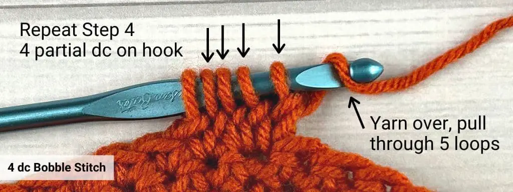 A four double crochet variation of a bobble stitch with orange yarn