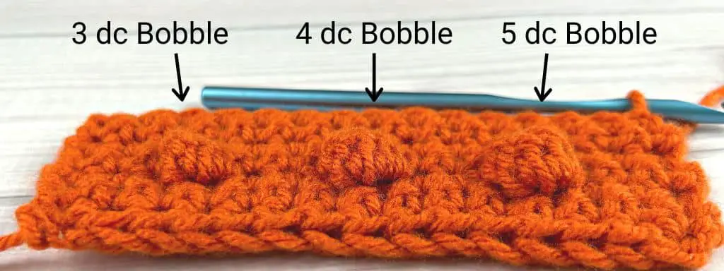 Comparison of different types of bobble stitches in orange yarn
