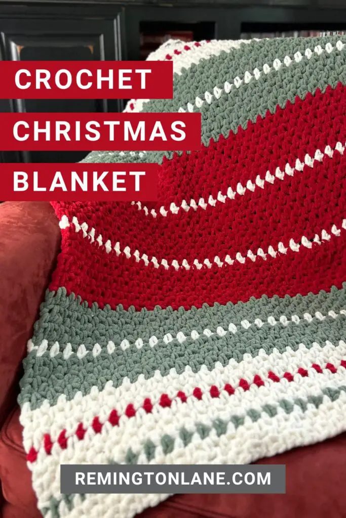 A Christmas colored crochet blanket spread out over a chair