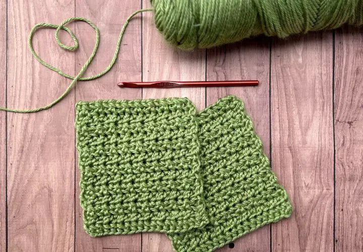 Two pistachio green crochet bonding squares laying on a table