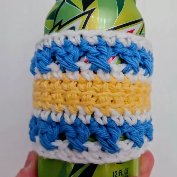 A blue and yellow striped drink cozy
