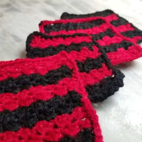 Red and black striped square coasters laying on a table