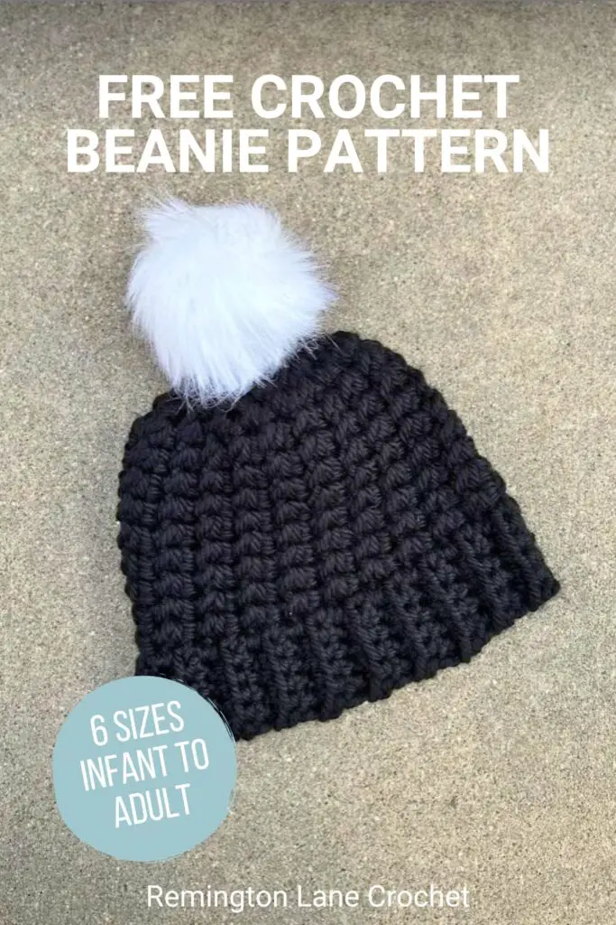 Black bulky and warm hat with white pom on top