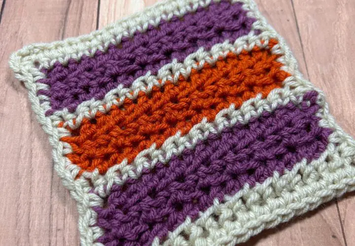 A close up of a small striped crocheted blanket square.