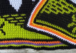 A closeup of the crochet envelope border for a Halloween mosaic crochet blanket.