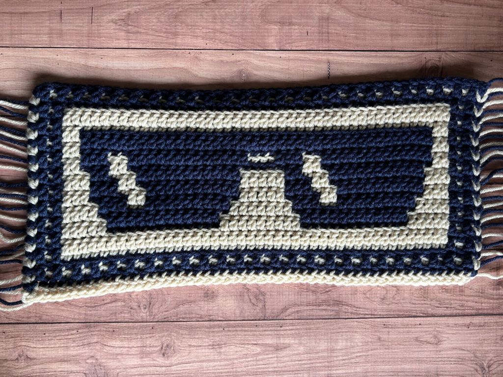A sample of mosaic sunglasses crocheted and laying on a table