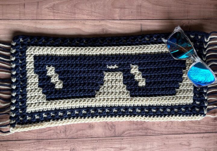 A sample of mosaic crochet sunglasses blanket section in beige and navy yarn.